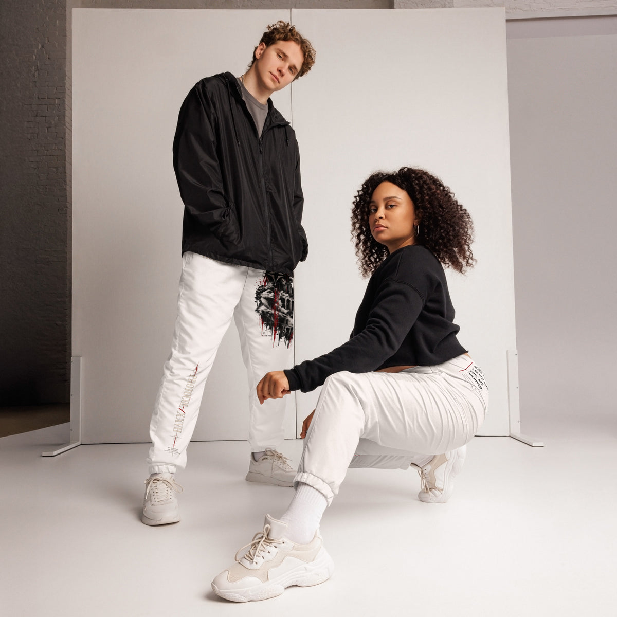 Black technical track pants by PROTOCOL XXVII, front view